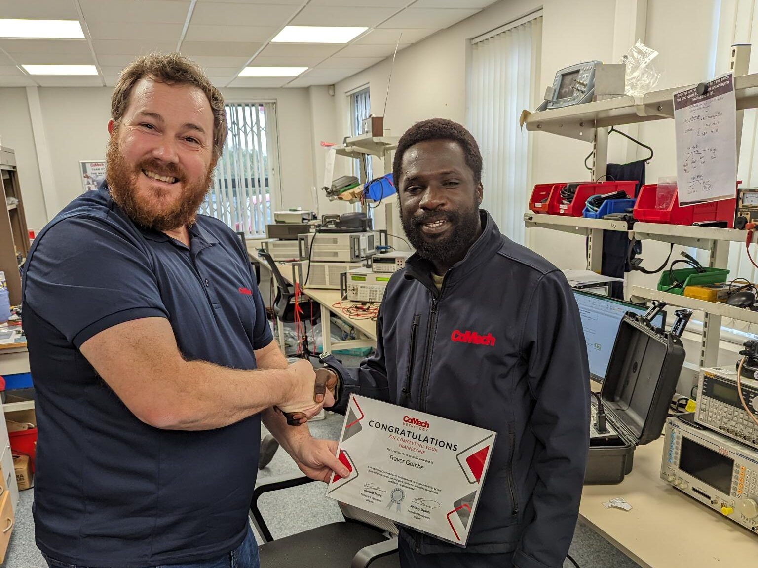 Employee receiving his training completion certificate from the Technical Manager